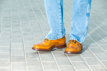 Closeup of Male Legs Wearing Leather Brown Oxford Semi Brogues Shoes
