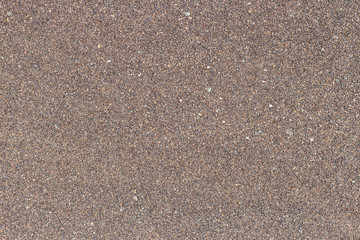 Background with brown fine sand of the sea coast