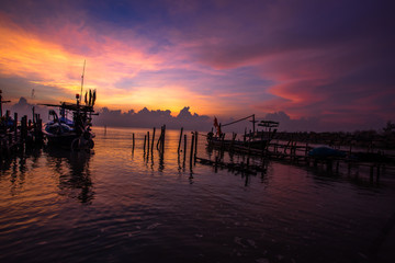 Panoramic wallpaper of the morning light scenery by the sea, with small fishing boats of the villagers landing, with blurred waves of sea, a beautiful way of life by the river community