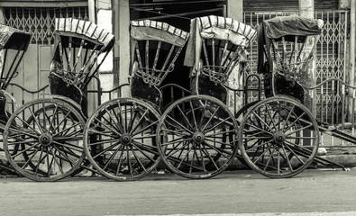 Hand-pulled Rickshaw parked at the Roadside.  Vintage effect is applied.