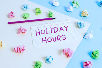 Fototapeta na wymiar Text sign showing Holiday Hours. Business photo text employee receives twice their normal pay for all hours Colored crumpled papers empty reminder blue yellow background clothespin