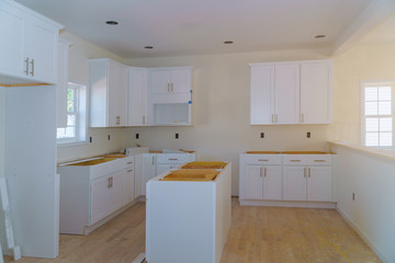 Custom kitchen cabinets in various stages of installation base for island in center