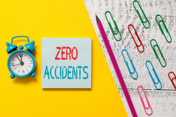 Handwriting text Zero Accidents. Conceptual photo important strategy for preventing workplace accidents Notepad marker pen colored paper sheet clips alarm clock wooden background