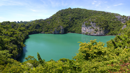 Thale Nai lagoon, the famous salt water Emerald Lake surrounded by lush tropical mountain green trees and lime stone rock cliff in Mae Koh island, Ang Thong National Marine Park, Suratthani,Thailand 