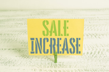 Text sign showing Sale Increase. Business photo showcasing Average Sales Volume has Grown Boost Income from Leads Green clothespin white wood background colored paper reminder office supply