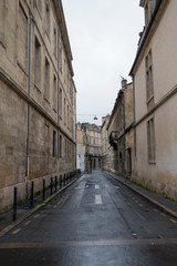 Fototapeta na wymiar Empty street lined with old buildings in Bordeaux