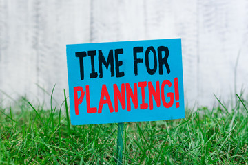 Handwriting text Time For Planning. Conceptual photo exercising conscious control spent on specific activities Plain empty paper attached to a stick and placed in the green grassy land