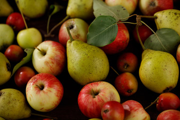 Background from ripe juicy pears and apples for your design. Close-up. Harvest.