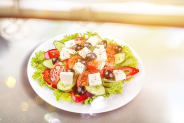 Greek salad with fresh vegetables on background