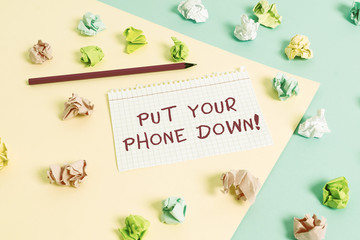 Fototapeta na wymiar Text sign showing Put Your Phone Down. Business photo text end telephone connection saying goodbye caller Colored crumpled papers empty reminder blue yellow background clothespin