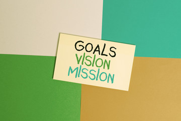 Text sign showing Goals Vision Mission. Business photo text practical planning process used to help community group Office appliance colorful square desk study supplies empty paper sticker