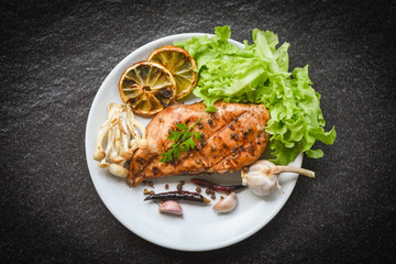chicken breast grilled with garlic chilli herbs and spices and fresh vegetables on plate top view - Roast BBQ chicken breast steak