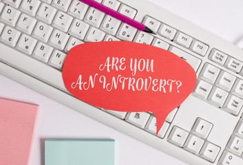 Writing note showing Are You An Introvertquestion. Business concept for demonstrating who tends to...