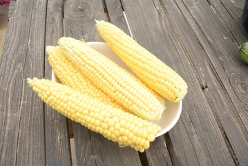 kidneys of raw corn lie on a dark wooden background