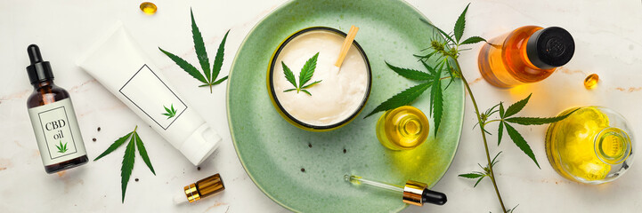 Cosmetics with cannabis oil on a turquoise plate on a light marble background. Concept of luxury skin care. Banner - obrazy, fototapety, plakaty