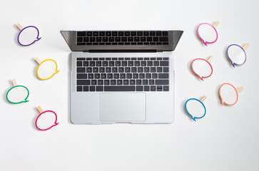 Social media concept with message bubbles and a laptop computer