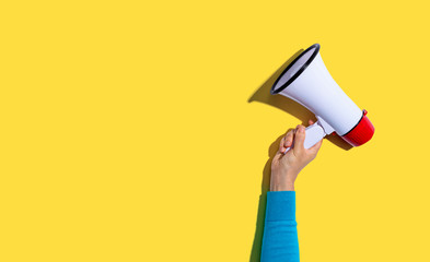 Person holding a megaphone with hard shadow