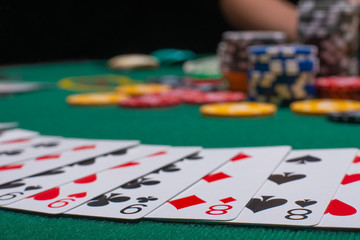 Close-up cards for playing poker on a gaming table in a casino against a background of chips. Background for a gaming business