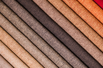 Colorful and bright fabric samples of furniture and clothing upholstery. Close-up of a palette of textile abstract stripes of different colors