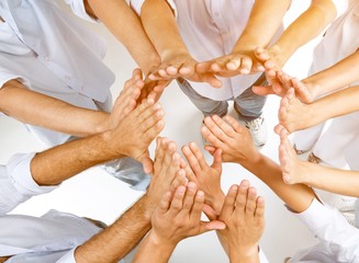 Close-up view of group of people stacking hands