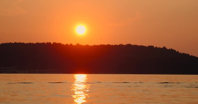 Red sunset on the lake slow motion