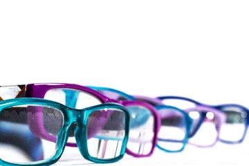 multiple colored eye glasses smudged and lined on white background. Eye Health Concept