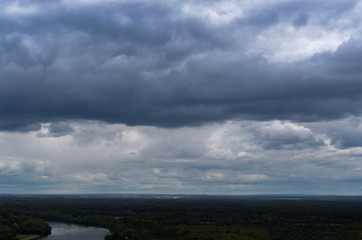 Rainy dark blue clouds hanging over the horizon