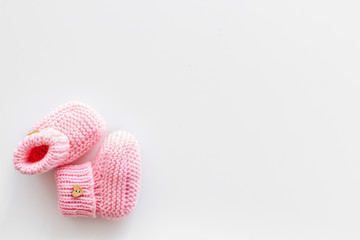Booties for newborn girl on white background top view mock up