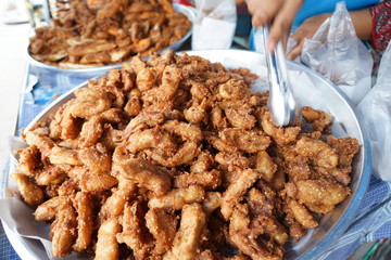 Banana fry in a pan with boiling oil. When finished, looks very appetizing