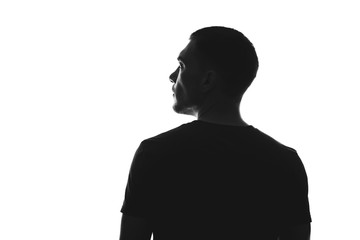 silhouette of man from behind on a white background looks away - Powered by Adobe