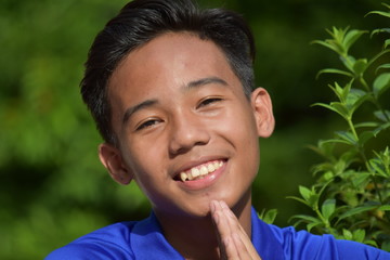 An Asian Teen Boy In Prayer