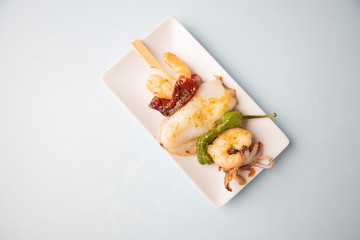 Skewer of sepia peppers and shrimp, typical Spanish tapa