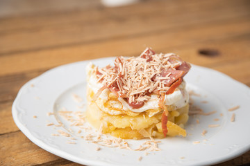 Spanish tapa, potato, fried egg, bacon and foie
