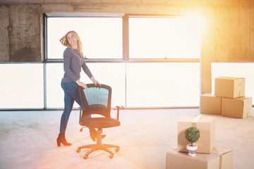 business woman pushing office chair