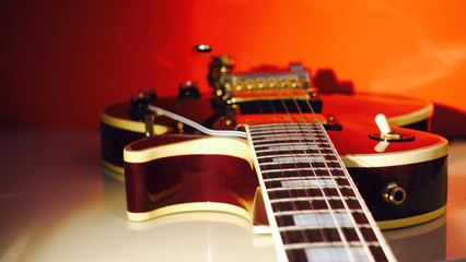 electric guitar . red background . closeup