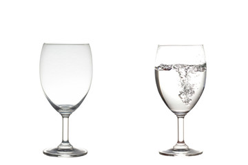 Empty,half water in wine glasses . Isolated on white