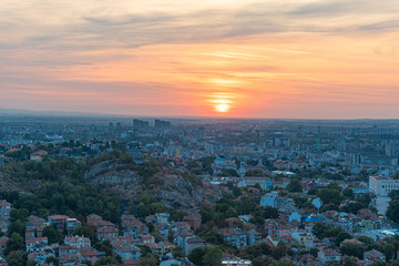 Beautiful sunrise with pink and yellow clouds above Plovdiv city 