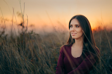 Fashion Portrait of a Happy Woman Admiring Sunset 