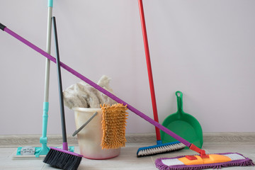 House cleaning with mop, cleaning equipment at the wall. MOP, bucket, dustpan, rag