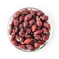 Dried wild rose berries in glass bowl isolated on white background with clipping path