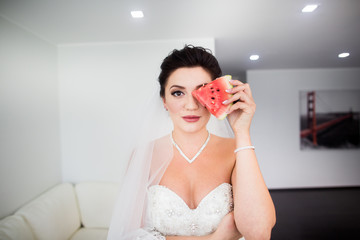 The bride eats tasty watermelon at home in the morning