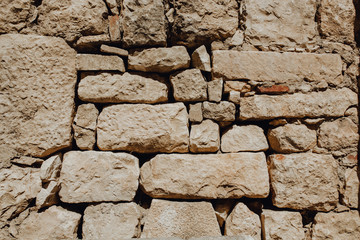 Old Stone Wall Rock Construction Background. Large Beige Block Surface Architecture Construction Concept Historical Building CloseUp. Macro Photo of Ancient Structure Landscape View