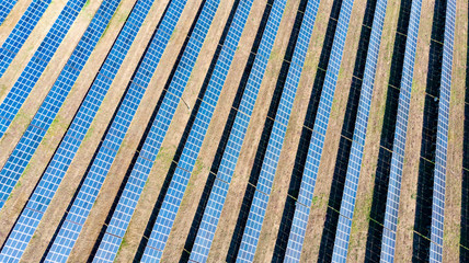 solar panels, desert. Solar energy farm. Top view of solar panels on the energy farm. Aerial view of the solar power plant. Industrial background on renewable resources.  large photovoltaic complex