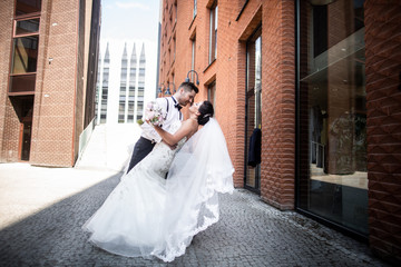 Bride and groom walking in the city, wedding day, marriage concept. Bride and groom in urban...