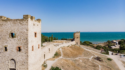 Fototapeta na wymiar Architectural landmark, sight Of Crimea. Genoese fortress in Sudak. Aerial view of the ruins of an ancient castle or fortress on a mountain by the sea. Beautiful summer tourist landscape 