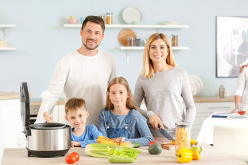 Obraz na płótnie Canvas Happy family with modern multi cooker in kitchen