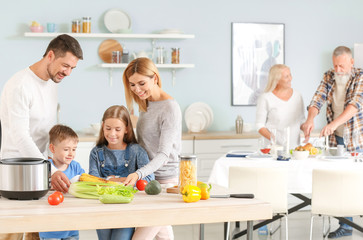 Happy family with modern multi cooker in kitchen