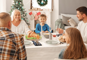 Happy family having Christmas dinner at home