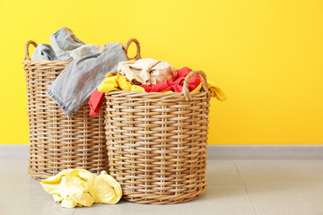 Baskets with dirty laundry on floor
