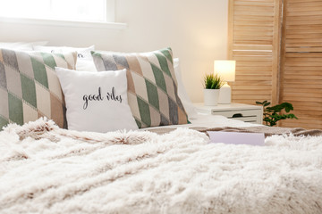 Big comfortable bed in stylish interior of room